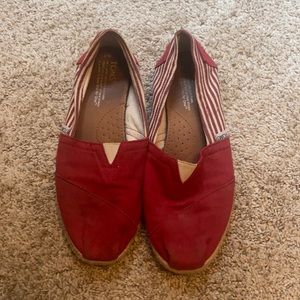 Tom’s red stripped flats